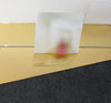 detail of sculpture blurry photgraph mounted on aluminium above gold reflective perspex